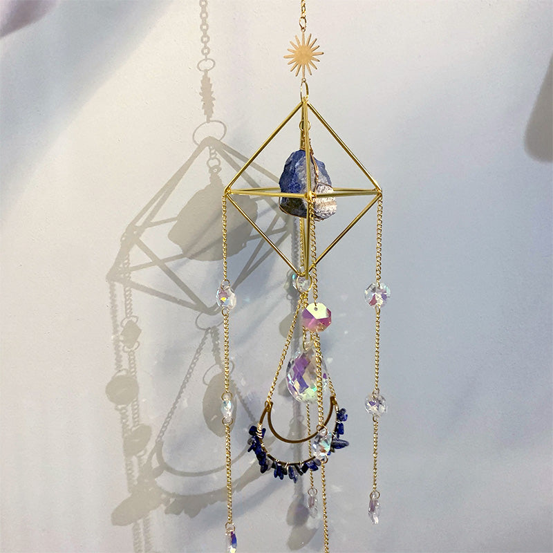 Raw Crystal Suncatcher (Lapis Lazuli) against the wall