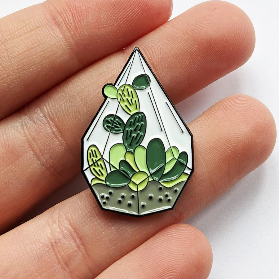Diamond Terrarium Enamel Lapel Pin in hand