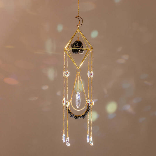 Raw Crystal Suncatcher (Obsidian) hanging