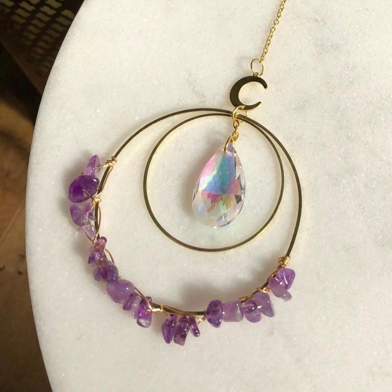 Hanging round quartz crystal chips suncatcher in sunlight