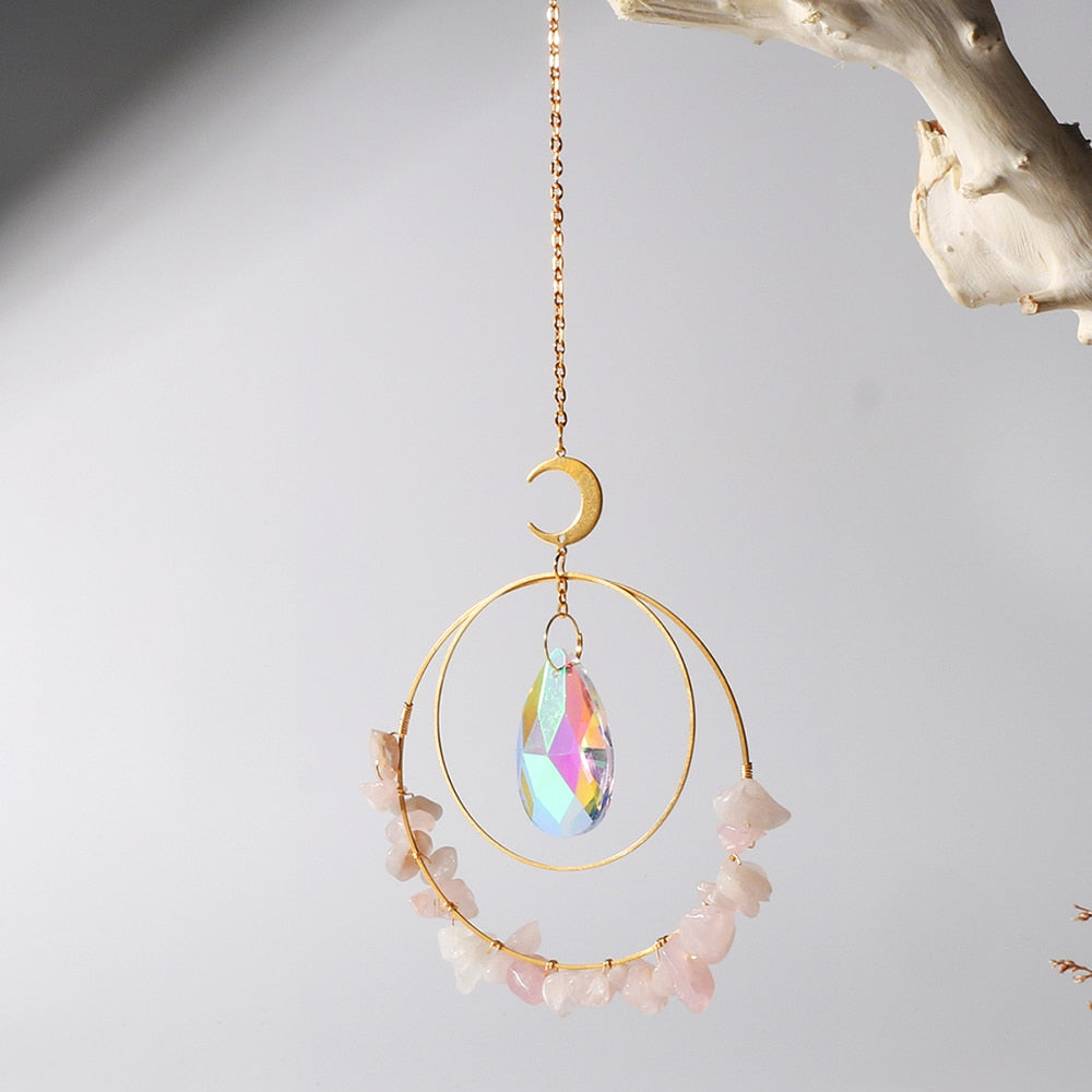Hanging round rose quartz crystal chips suncatcher in sunlight