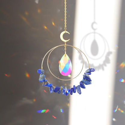 Lapis Lazuli hanging quartz crystal suncatcher in sunlight making rainbow