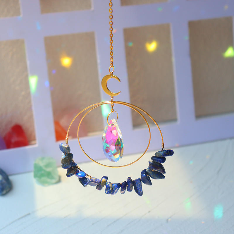 Lapis Lazuli hanging quartz crystal suncatcher in sunlight making rainbow