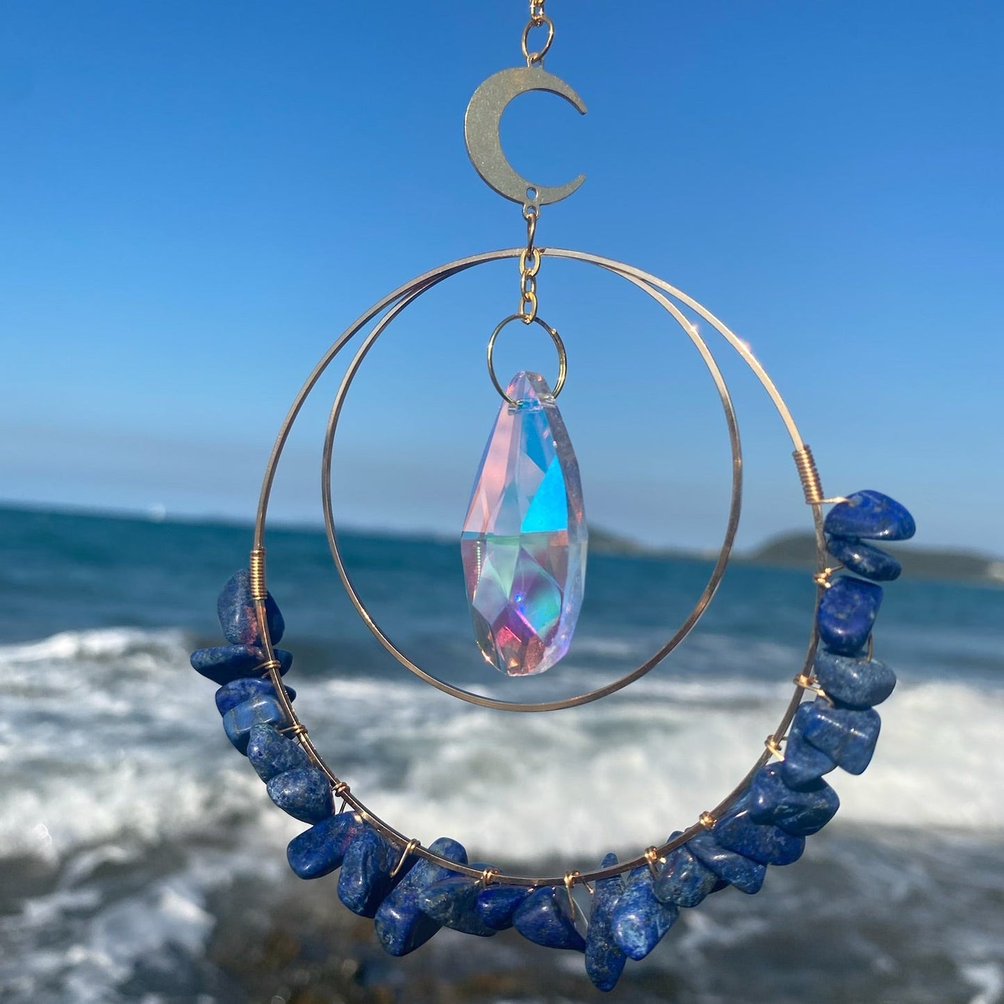 Lapis Lazuli hanging quartz crystal suncatcher in sunlight 