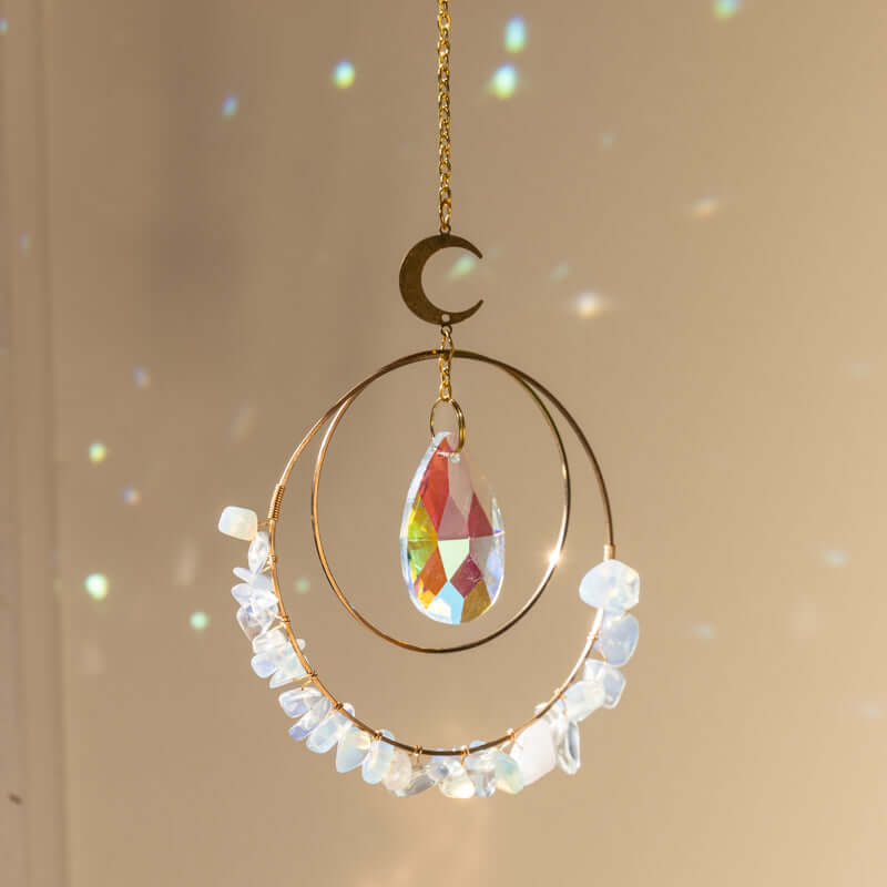 Opalite hanging crystal quartz suncatcher in sunlight making rainbow