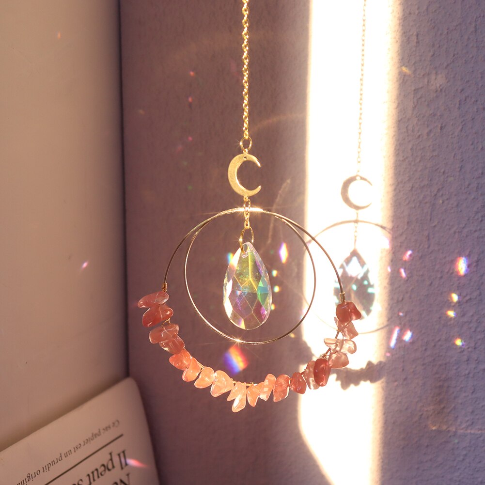 Red Melting Hanging quartz crystal suncatcher in sunlight making rainbow